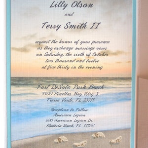 May include: A wedding invitation with a beach scene background. The invitation is for Lilly Olson and Terry Smith II. The ceremony will be held at Fort DeSoto Park Beach in Tierra Verde, Florida on October 6, 2012 at 5:30 PM. The reception will follow at the American Legion in Madeira Beach, Florida.