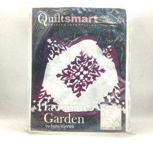 May include: Quiltsmart printed interfacing pattern for a Hawaiian Garden quilt. The pattern features a white background with a burgundy floral design. The pattern is by Bettie Runnels.