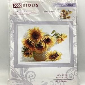 May include: Cross-stitch pattern featuring a bouquet of sunflowers in a vase with a butterfly. The pattern is titled "Hot Summer" and is 15 3/4 inches by 11 3/4 inches.