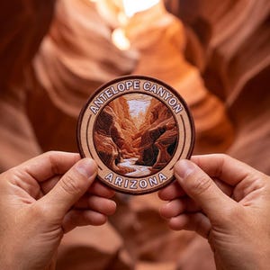 May include: A round embroidered patch featuring a detailed landscape of Antelope Canyon in Arizona. The patch is brown and tan with the words "Antelope Canyon" and "Arizona" in a circular design.