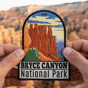 May include: A patch featuring a landscape of Bryce Canyon National Park. The patch has a black border and includes the text "BRYCE CANYON National Park" in white. The image depicts orange rock formations under a blue sky with the year "1928".