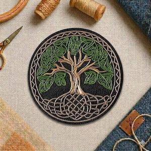 May include: Round black patch with a detailed embroidered Tree of Life design. The tree features green leaves, a tan trunk, and intertwined roots. The patch is surrounded by a decorative border.
