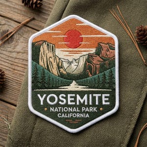May include: A hexagonal embroidered patch featuring a landscape of Yosemite National Park with a red sun, tan cliffs, and green pine trees. The text reads YOSEMITE NATIONAL PARK CALIFORNIA in white capital letters against a dark green background.