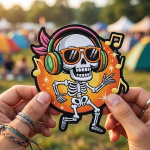 May include: Embroidered patch featuring a dancing skeleton wearing sunglasses and headphones. The patch has an orange background with musical notes. The skeleton is white with black outlines, and the headphones are green and pink.