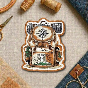 May include: Embroidered patch featuring a detailed backpack design with a compass, a rolled-up sleeping bag, and the text "TIME FOR NEW ADVENTURE." The patch is in shades of brown, tan, and green, with a white border. Perfect for adding to jackets, bags, or other items.
