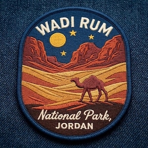 May include: An oval embroidered patch featuring a desert landscape with a camel in the foreground, rocky mountains, a yellow moon, and three stars. The text reads WADI RUM at the top and National Park, JORDAN at the bottom in white lettering.