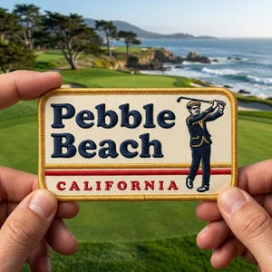 May include: A rectangular patch with the words "Pebble Beach CALIFORNIA" in navy blue and red. The patch features an illustration of a golfer in a navy suit. The patch has a gold border and is held by two hands.