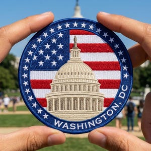 May include: A circular embroidered patch featuring the United States Capitol building in beige thread against a background of the American flag. The border is dark blue with white stars and the text WASHINGTON, DC in white capital letters.