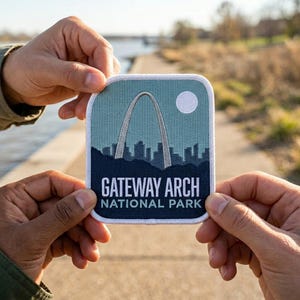 May include: A square patch featuring the Gateway Arch National Park. The patch has a white border and a design of the arch, a cityscape, and a white circle. The text "GATEWAY ARCH NATIONAL PARK" is displayed in white letters on a navy blue background.