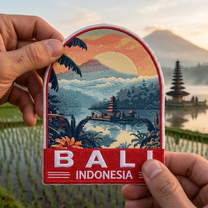 May include: Embroidered patch featuring a scenic view of Bali, Indonesia, with a sunset over a mountain and water. The patch has a red border and the word "BALI" and "INDONESIA" in white text.