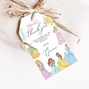 May include: A white gift tag with a pink bow and watercolor illustrations of princesses. The tag reads "thank you" and "For celebrating my magical day with me! Love, Emma."