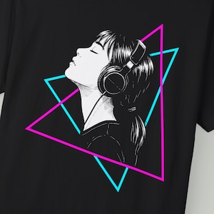 May include: Black t-shirt featuring a black and white illustration of a person wearing headphones, eyes closed. A pink and blue triangle graphic frames the person's head. The design has a retro, 80s aesthetic.