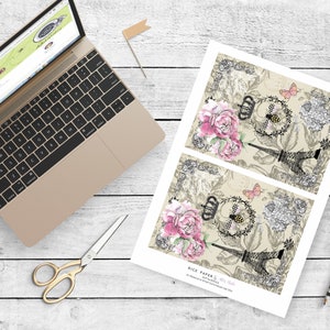 May include: Two sheets of decorative rice paper with a vintage Parisian theme. The paper features a black and white illustration of the Eiffel Tower, pink and white flowers, a bee, and a butterfly. The text "Rice Paper &  Jet-Set Style" is printed at the bottom of the sheet.