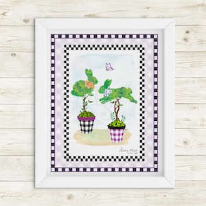 May include: A framed print with a black and white checkered border. The print features two topiary trees shaped like bunnies in pink and white pots. A butterfly is flying above the trees. The print is titled "Allison Marie for Ella Studio".
