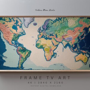 May include: A colorful world map displayed as frame TV art. The map features a textured, artistic rendering of continents and oceans in shades of blue, green, yellow, and orange, set within a light brown wooden frame. The text "FRAME TV ART" is visible at the bottom.