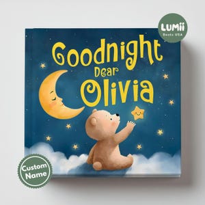May include: A children's book cover with a night sky theme. The title "Goodnight Dear Olivia" is in yellow script. A cartoon bear reaches for a smiling star. A crescent moon and clouds are also featured.