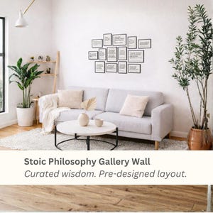 Peut inclure: Un salon moderne avec un canapé gris clair, des coussins beiges et une table basse ronde blanche. Un mur de galerie de citations encadrées est au-dessus du canapé. Le texte en bas indique "Stoic Philosophy Gallery Wall". Des plantes et un tapis sont également visibles.