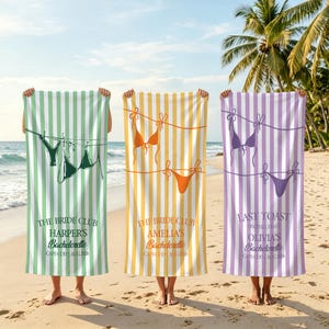 May include: Three striped beach towels in green, yellow, and purple, each with a bikini design. Text on the towels reads: "THE BRIDE CLUB HARPER'S Bachelorette CAPE COD AUG 2006", "THE BRIDE CLUB AMELIA'S Bachelorette CAPE COD AUG 2006", and "LAST TOAST OLIVIA'S Bachelorette CAPE COD AUG 2006".
