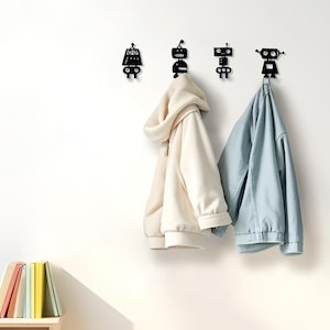 May include: A set of three ceramic mugs with a speckled, cream-colored glaze. Each mug features a different hand-painted floral design in shades of blue, green, and yellow. The mugs have a simple, rounded shape and a comfortable handle.