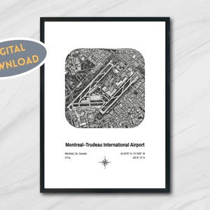 May include: Black and white aerial view print of Montreal-Trudeau International Airport. The print includes the airport's name, location, and coordinates. A digital download sticker is in the upper left corner. The print is in a black frame.