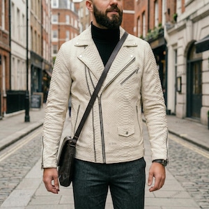 May include: A white ceramic mug with a black handle and the text "But First, Coffee" in a black, handwritten-style font. The mug is on a white surface.