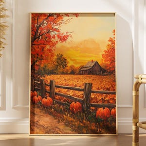 Puede incluir: Una impresión de arte mural rectangular vertical con una pintura de paisaje otoñal. La escena muestra un granero de madera rústico en un campo de calabazas naranjas, una valla de madera desgastada y árboles de tonos rojos y naranjas vibrantes.