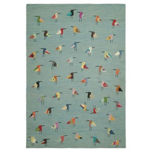 May include: A rectangular area rug featuring a light blue background with a repeating pattern of small, stylised birds. Each bird is rendered in a variety of different colours and geometric patterns, distributed across the entire surface of the rug.