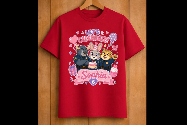 May include: Red t-shirt featuring a colorful graphic with the text "Let's Celebrate!" and the name "Sophia" with the number "6". The design includes cartoon characters, balloons, a cake, and a cupcake.