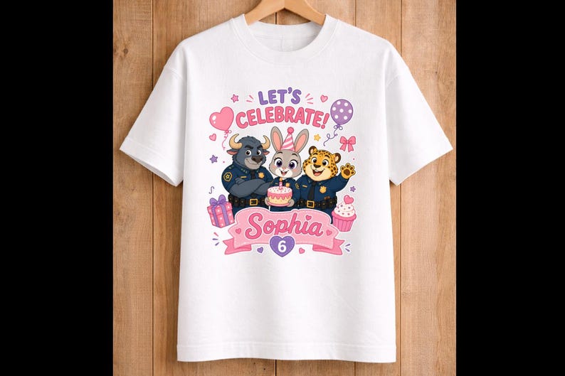 May include: White t-shirt with a colorful graphic featuring three cartoon animal characters in police uniforms, a cake, balloons, and the text "Let's Celebrate!" and "Sophia 6".