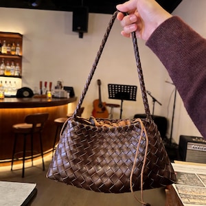 May include: A set of three ceramic mugs with a speckled, matte finish. The mugs are in shades of cream, light gray, and dark gray. Each mug has a simple, minimalist design, perfect for coffee or tea.