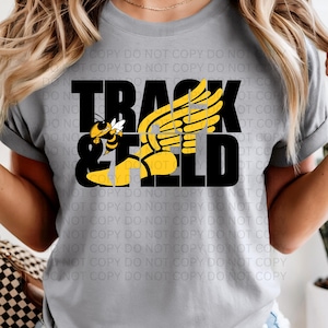 May include: A light gray t-shirt with the words "TRACK & FIELD" in black block letters. A yellow and black bee graphic is on the left, and a yellow wing design is on the right.