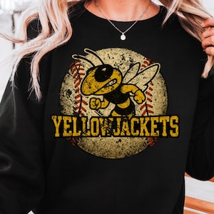 May include: Black sweatshirt featuring a distressed graphic of a yellow and black bee with the text "YELLOW JACKETS" in a vintage style. The bee is set against a baseball background.