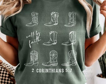 May include: Dark green t-shirt featuring a white graphic of cowboy boots arranged in a grid pattern. The text "walk by faith" and "2 Corinthians 5:7" are also printed on the shirt.