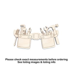May include: A wooden tool belt cutout featuring various tools such as a hammer, wrench, pliers, and screwdriver. The belt has two pockets and a buckle. The text at the bottom says, "Please check exact measurements before ordering. See listing images & listing info."
