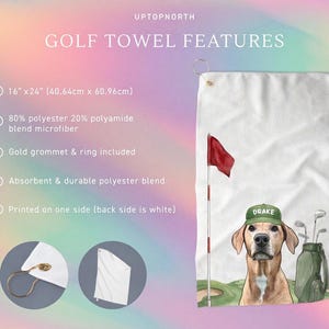 May include: White golf towel with a red flag, a dog wearing a green cap with the name "Drake", and golf clubs. The towel is 16" x 24" and made of a polyester blend. Features a gold grommet and ring.