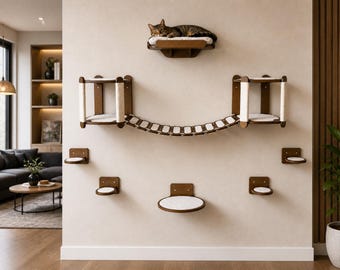 May include: A modern cat wall furniture set in a living room. The set includes multiple platforms, a bridge, and a cat bed. The platforms and bed have white cushions. The cat furniture is made of wood and is mounted on a beige wall.