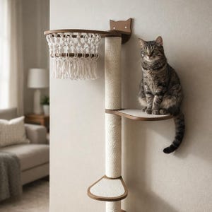 May include: A cat sits on a multi-level cat tree with a basketball hoop design. The tree features a brown wooden frame, a sisal scratching post, and a macrame net. The cat is gray and brown with green eyes.