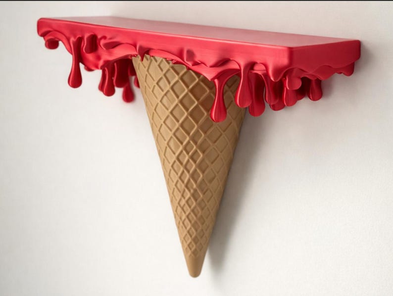 May include: A wall-mounted shelf shaped like an upside-down ice cream cone. The top flat surface features a glossy red finish with sculpted drips hanging over the edges, while the base is a textured, tan, waffle-patterned cone shape.