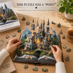 May include: A wooden puzzle depicting a 3D castle emerging from an open book. The puzzle features gray stone towers, green landscape details, and warm interior lighting. The box is labeled "WOODEN PUZZLE Magic Castle" and "THIS PUZZLE HAS A POINT".