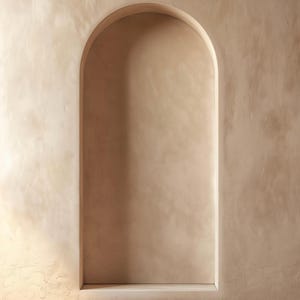 May include: A beige wall featuring a recessed arched alcove. The wall has a textured, stucco-like finish in a warm, neutral tone. The alcove is a slightly darker shade of beige, providing a gentle contrast. The overall design is minimalist and earthy.