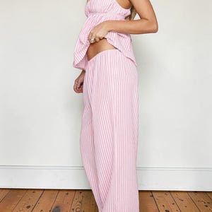Full-length side profile of the pink striped pajama set highlighting the flowy wide-leg design and comfortable elastic waistband.