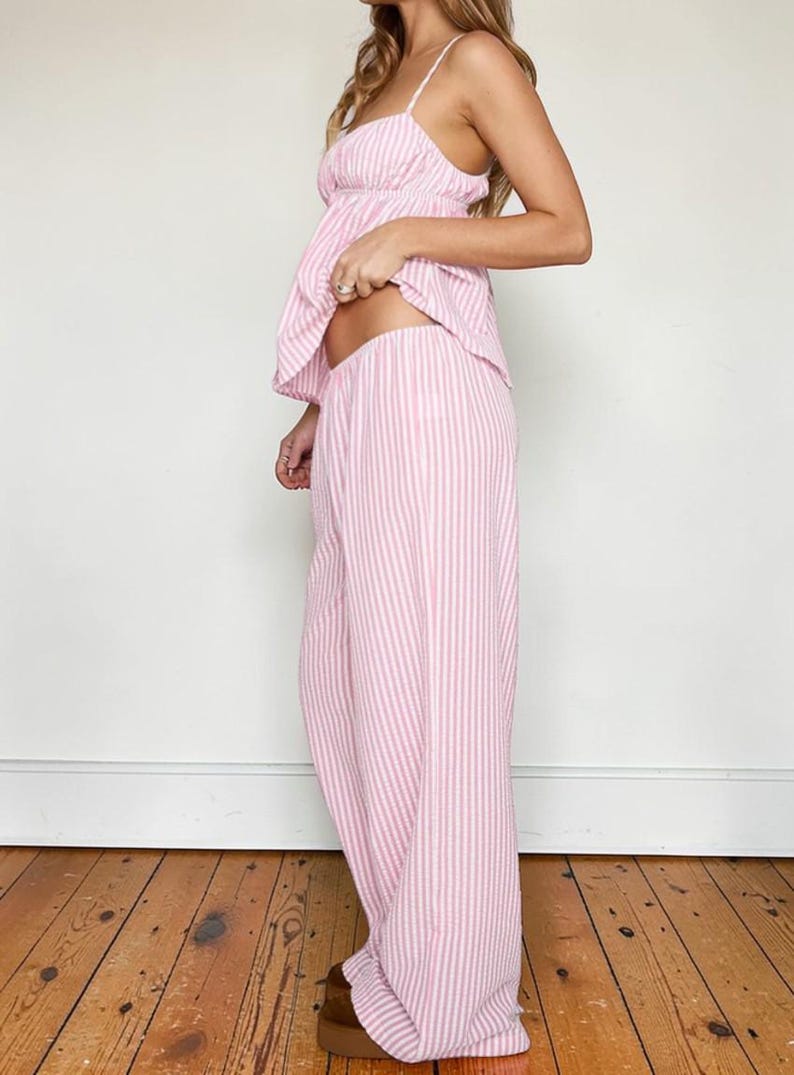 Full-length side profile of the pink striped pajama set highlighting the flowy wide-leg design and comfortable elastic waistband.