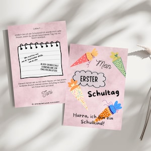 Puede incluir: Dos tarjetas rosas con texto e ilustraciones para el primer día de escuela de un niño. Una tarjeta tiene un diseño de bloc de notas con detalles del evento. La otra tarjeta dice "Mi primer día de escuela" con ilustraciones coloridas en forma de cono.