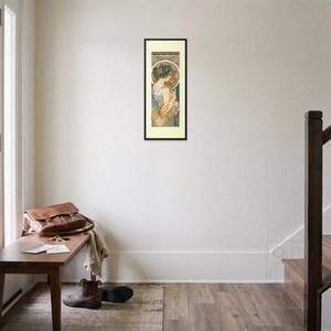Alphonse Mucha Art Nouveau Print framed art print, 16x40 inch, black wood frame, shown hanging in an entryway