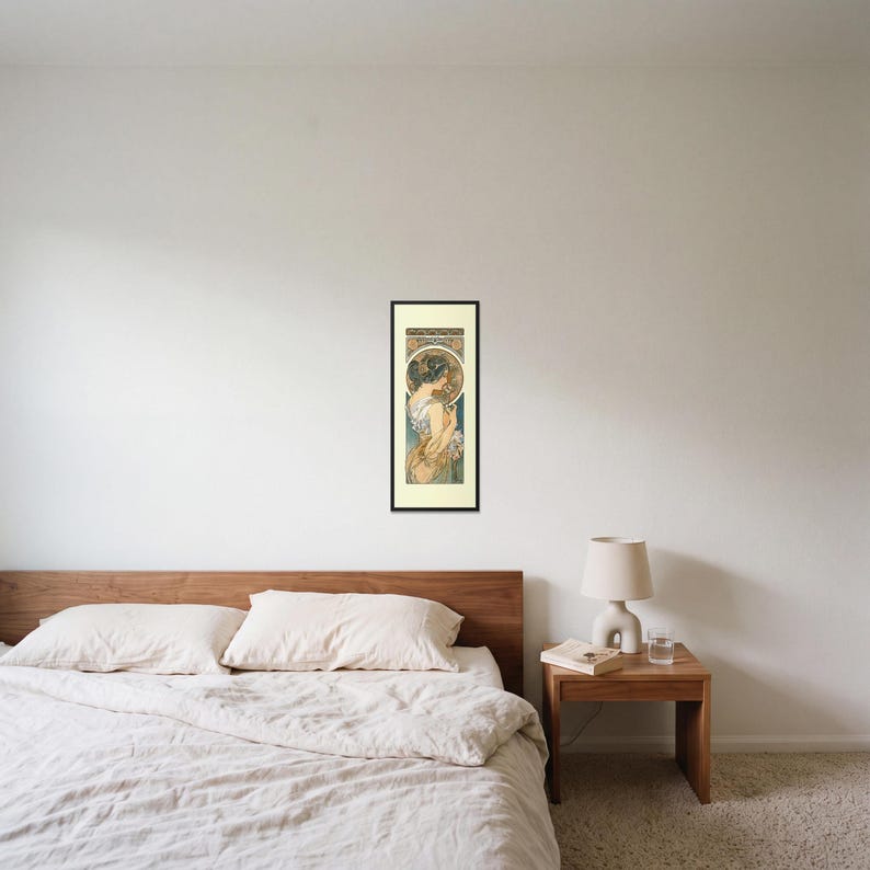 Alphonse Mucha Art Nouveau Print framed art print, 16x40 inch, black wood frame, shown hanging above a bed