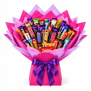 May include: A bouquet arrangement of various chocolate candy bars including brands like Kinder, Snickers, Lion, Wispa, and Maltesers. The bars are wrapped in bright pink and light purple tissue paper and held in a pink box with a purple satin bow.
