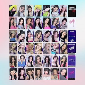 May include: A collection of K-pop idol photo cards and album inserts. The cards feature various young women in different poses and outfits. Some cards have the word "DRIP" and "BABYMONSTER" printed on them.