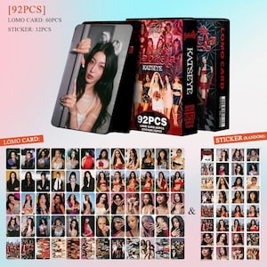May include: A set of K-pop themed Lomo cards and stickers. The set includes 60 Lomo cards and 32 stickers. The cards feature images of a K-pop group. The packaging includes the text "KATSEYE" and "92PCS".