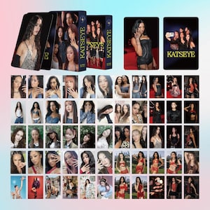 May include: A collection of KATSEYE trading cards featuring various images of the group members. The cards are displayed with a box set and individual cards, showcasing diverse poses and styles. The KATSEYE logo is visible.