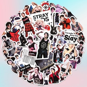 May include: A collection of Stray Kids stickers featuring various members in different poses. The stickers showcase the band's logo and the text "STRAY KIDS" and "Stay". The stickers are in various colors and designs.